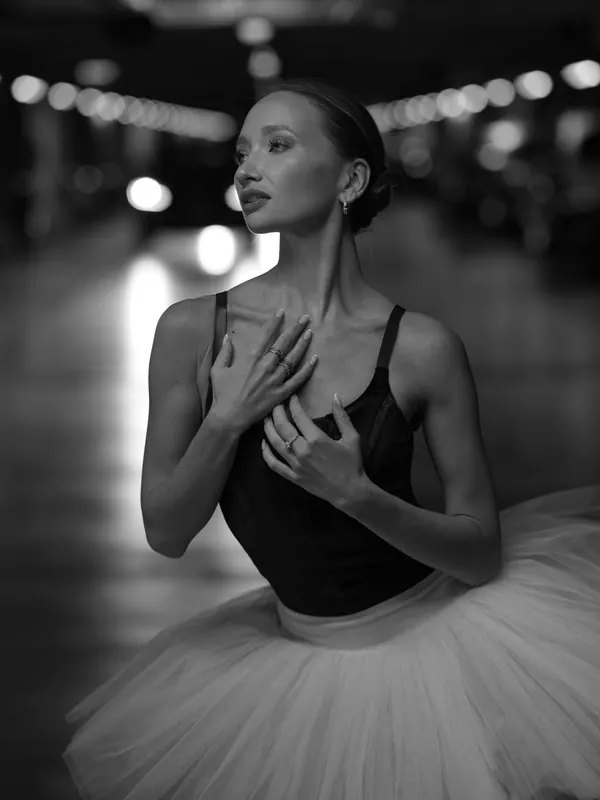 Black-and-white portrait of Zuza in a tutu, hands at her heart